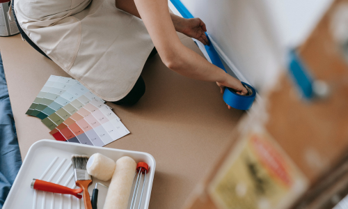 Woman laying down paint tape