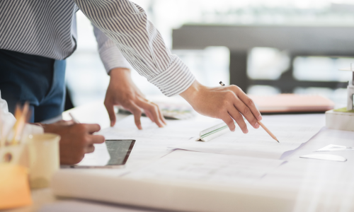 Man writing blueprints