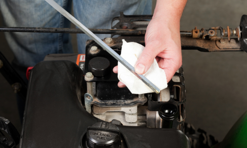 Small engine oil being checked