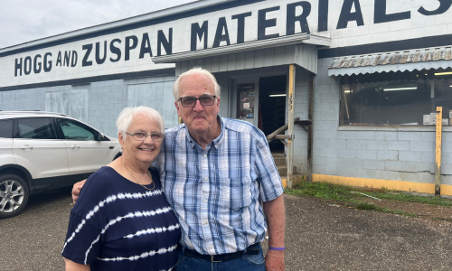 The owners of H&Z standing outside of the store front.